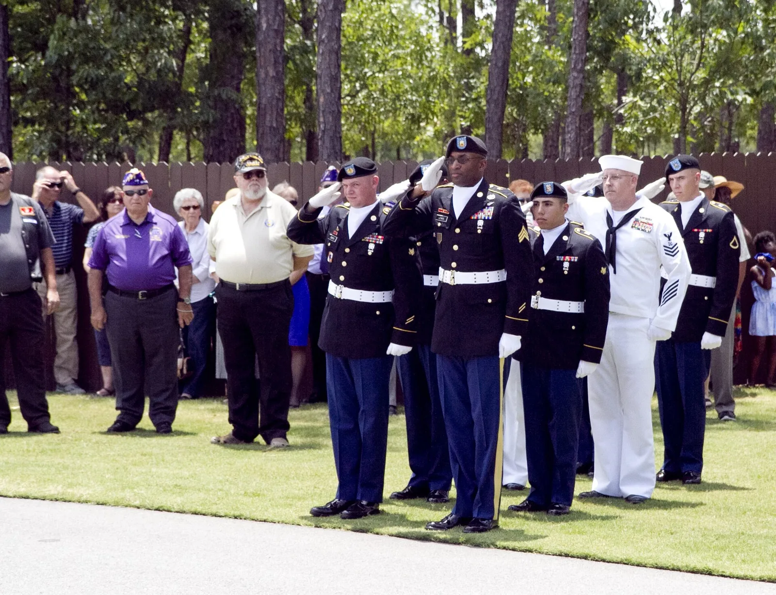A military honor guard salutes during a burial with full honors at Fort Jackson National Cemetery in Columbia, S.C.