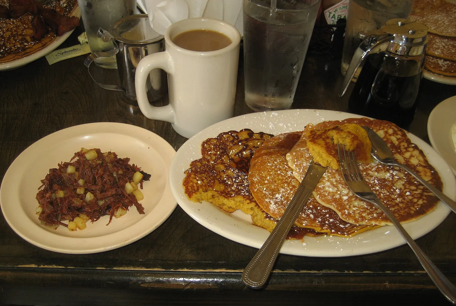 Pancakes with a side of hash at a restaurant in New Orleans, not in Augusta.