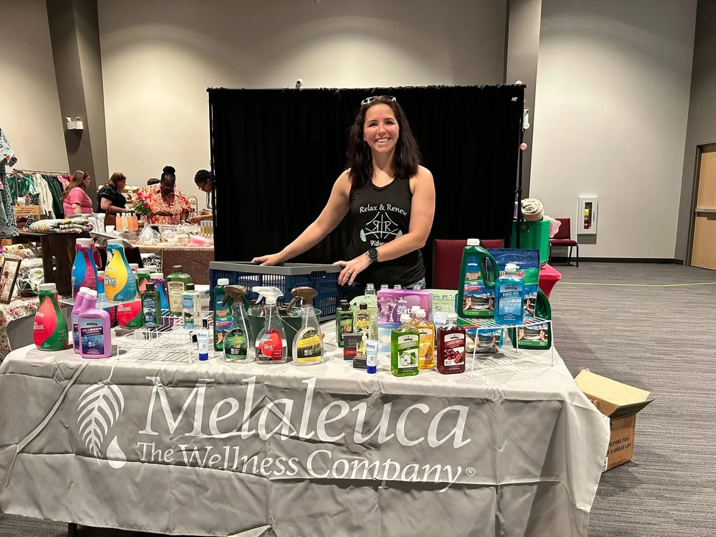 A vendor table of Melaleuca cleaning and wellness products