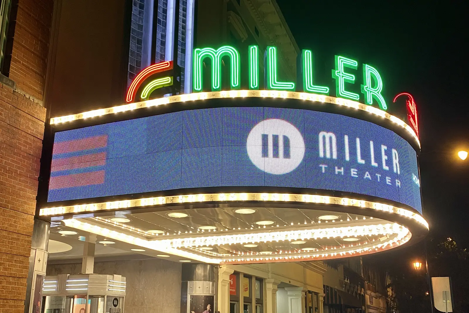 The lit marquee of the Miller Theater on Broad Street in downtown Augusta, where the city's ghost walks begin.