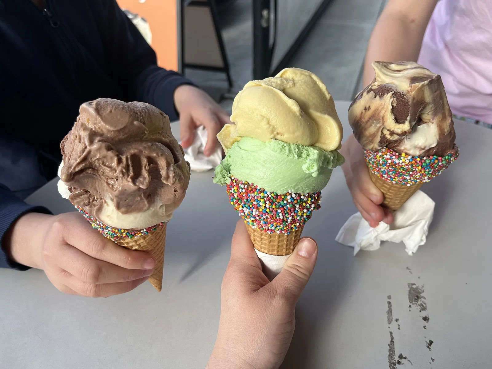 Three ice cream cones with sprinkles. The photo was not taken at an Augusta shop.