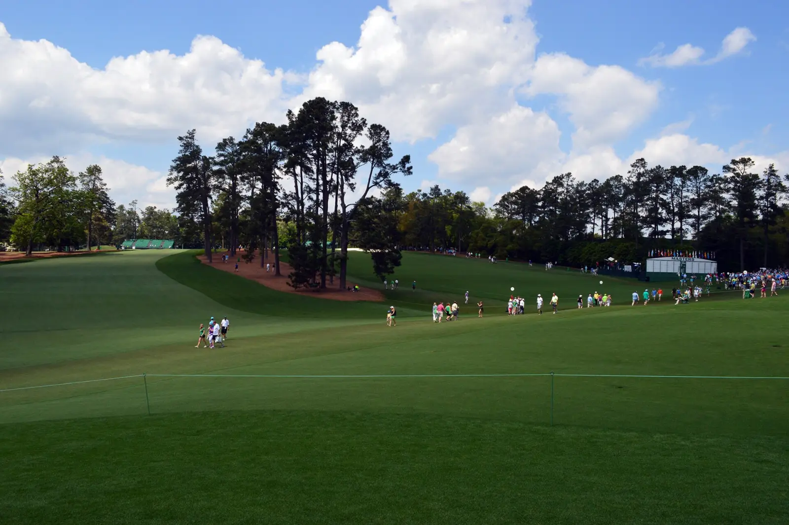 Patrons walk the course at Augusta National Golf Club during a Masters practice round.