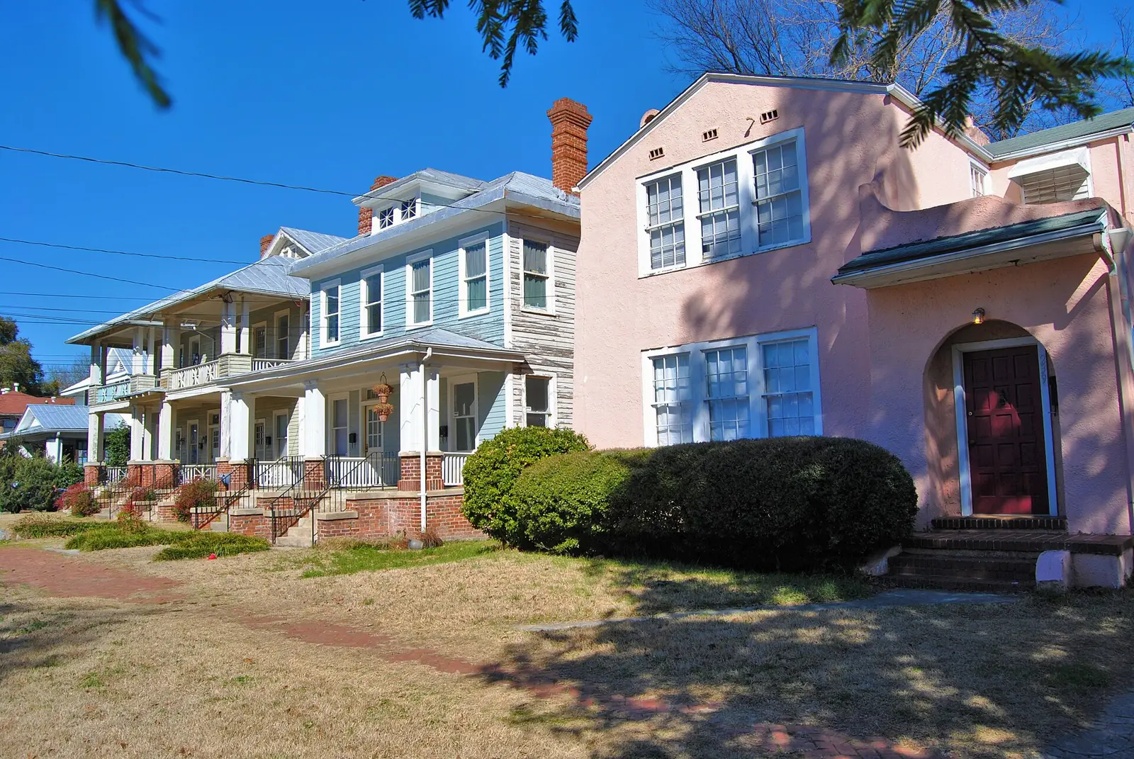 Porches and a pink stucco house on Broad Street in Olde Town, the old Pinched Gut neighborhood a few blocks from the state fairgrounds