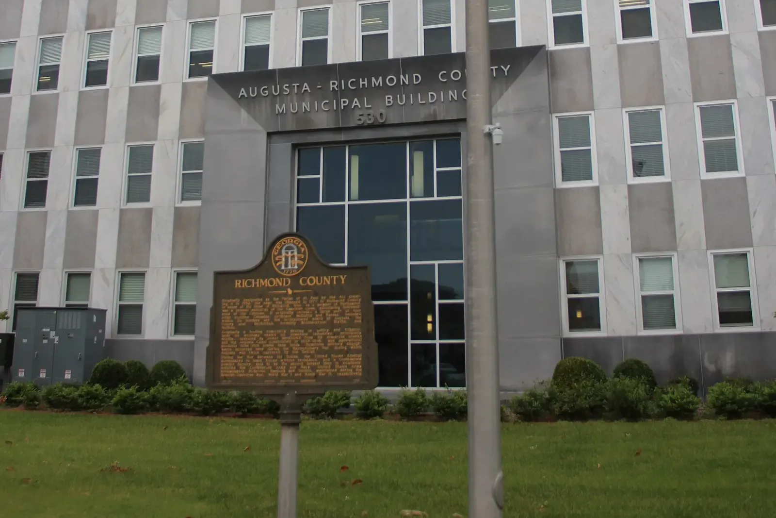 The entrance of the Augusta-Richmond County Municipal Building on Telfair Street, with a Richmond County historical marker.